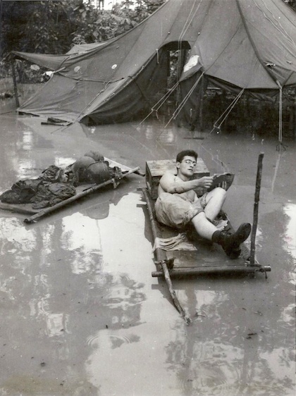 Soldier reading in the tropics